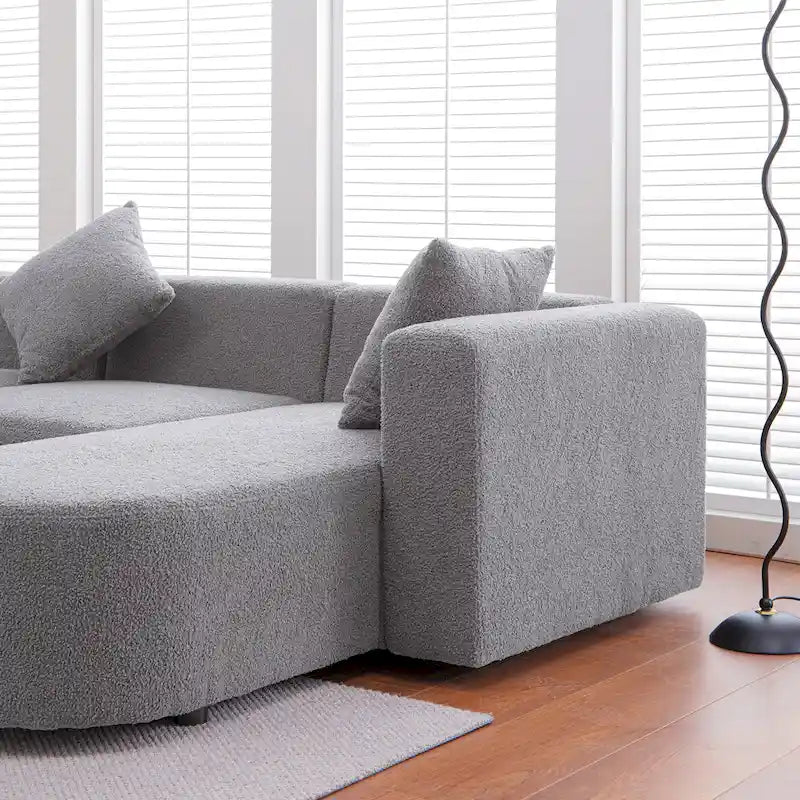 Modernes L-förmiges Bouclé-Sofa mit geschwungener Sitzfläche (rechtsseitig ausgerichtet)